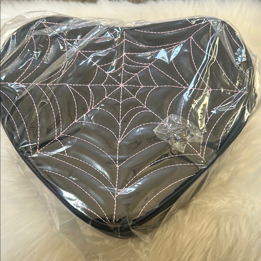 Pumpkin Kult Venmo’s Heart-Shaped Black backpack/crossbody bag.